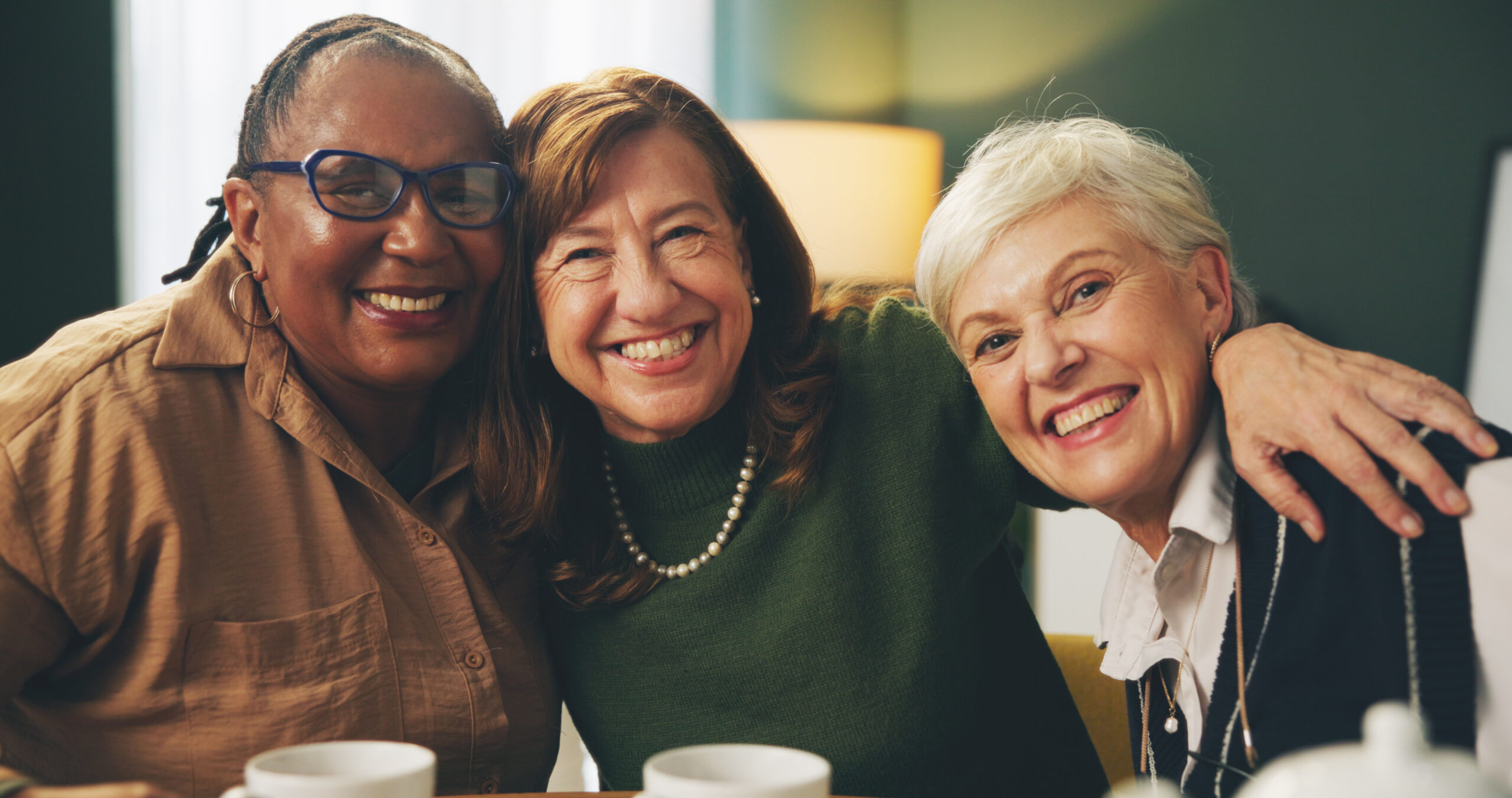 Happy, hug and portrait of senior women in house with care, trust and support, relax and bonding wi.
